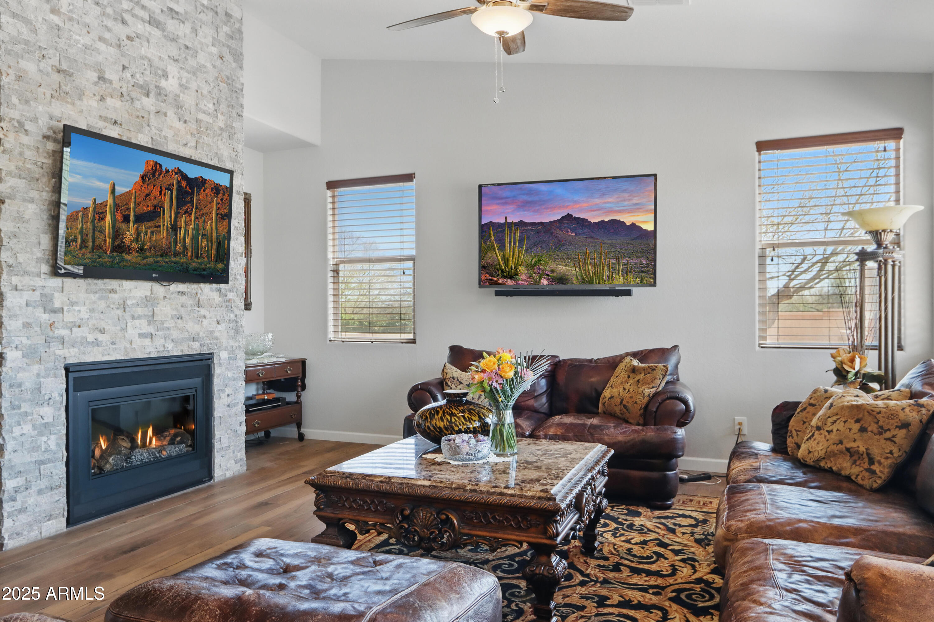 19023 East Buckskin Drive Rio Verde, AZ 85263 - Photo 18 of 58 a living room with furniture a flat screen tv and a fireplace