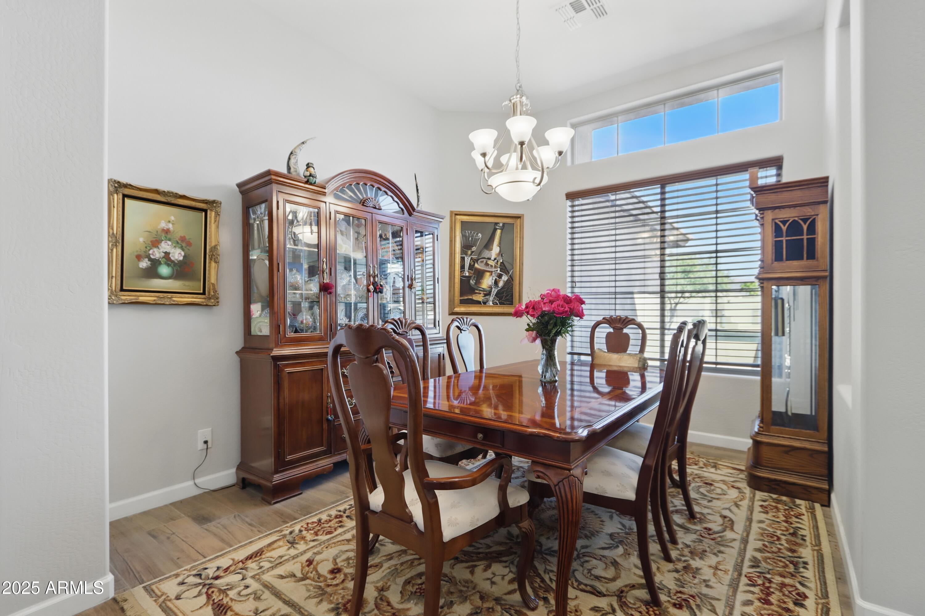 19023 East Buckskin Drive Rio Verde, AZ 85263 - Photo 20 of 58 a view of a dining room with furniture a chandelier and wooden floor