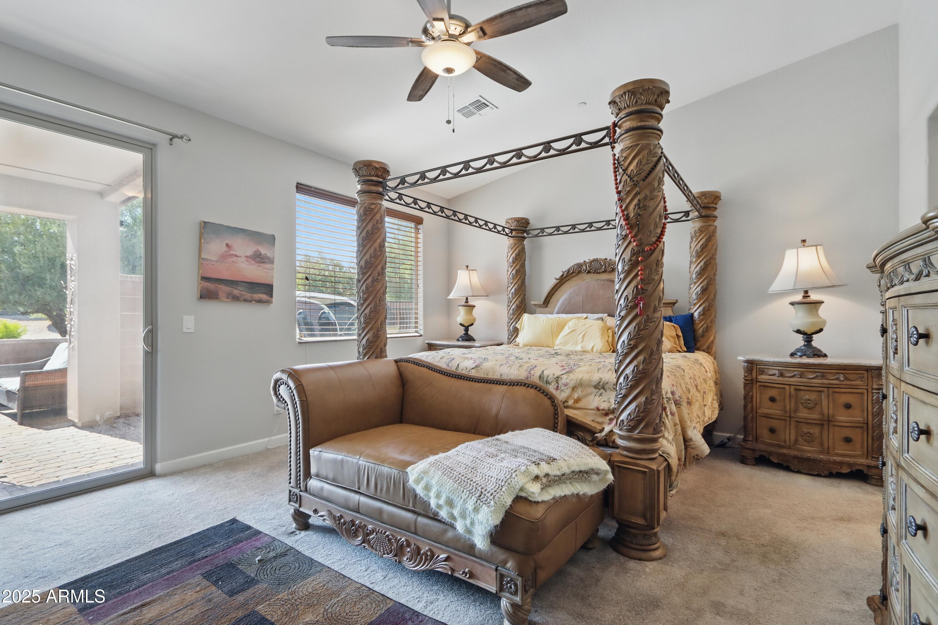 19023 East Buckskin Drive Rio Verde, AZ 85263 - Photo 23 of 58 a bedroom with a bed and a chandelier