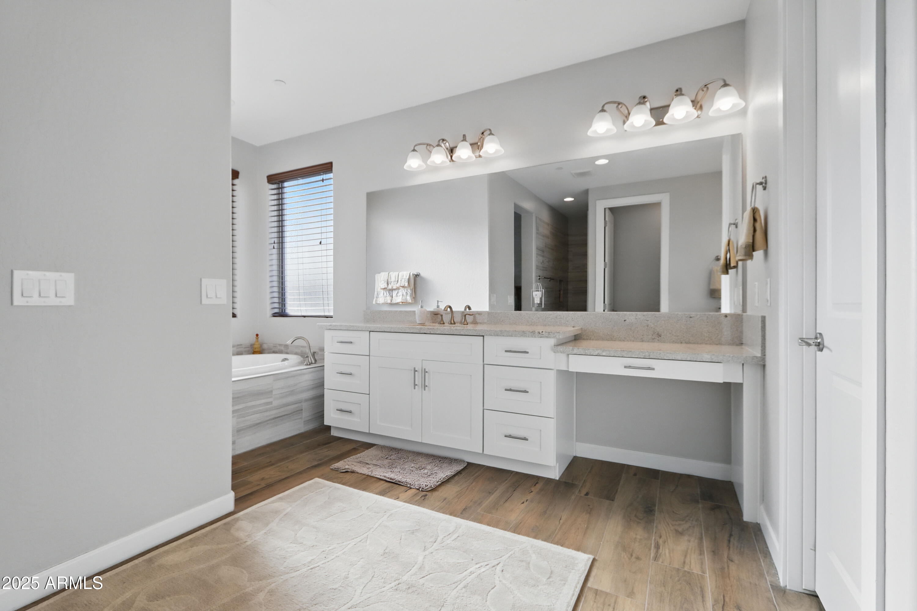 19023 East Buckskin Drive Rio Verde, AZ 85263 - Photo 28 of 58 a spacious bathroom with a double vanity sink a mirror and a bathtub
