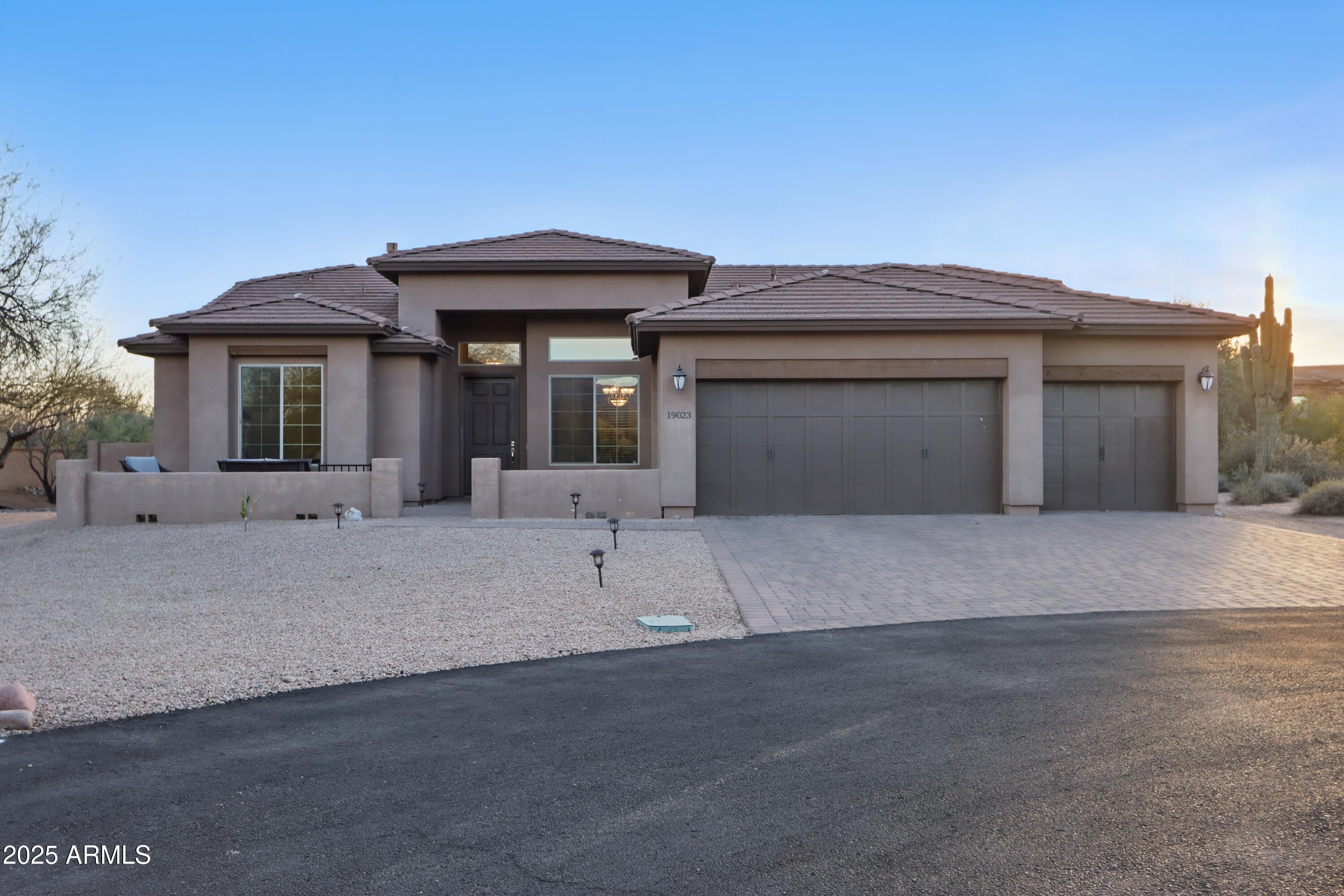 19023 East Buckskin Drive Rio Verde, AZ 85263 - Photo 29 of 31 a front view of a house with a yard and garage