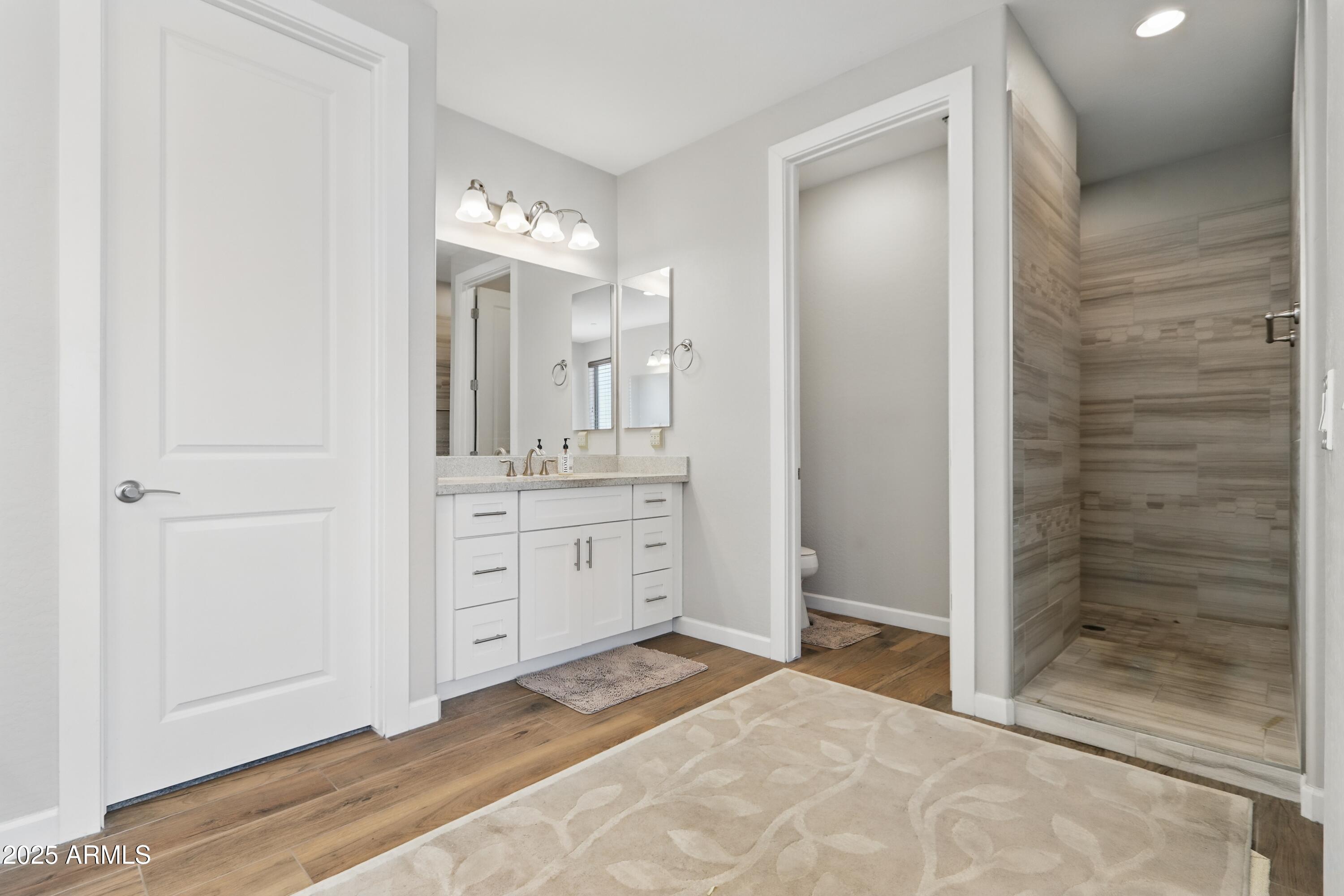 19023 East Buckskin Drive Rio Verde, AZ 85263 - Photo 31 of 58 a bathroom with a double vanity sink a mirror and a shower