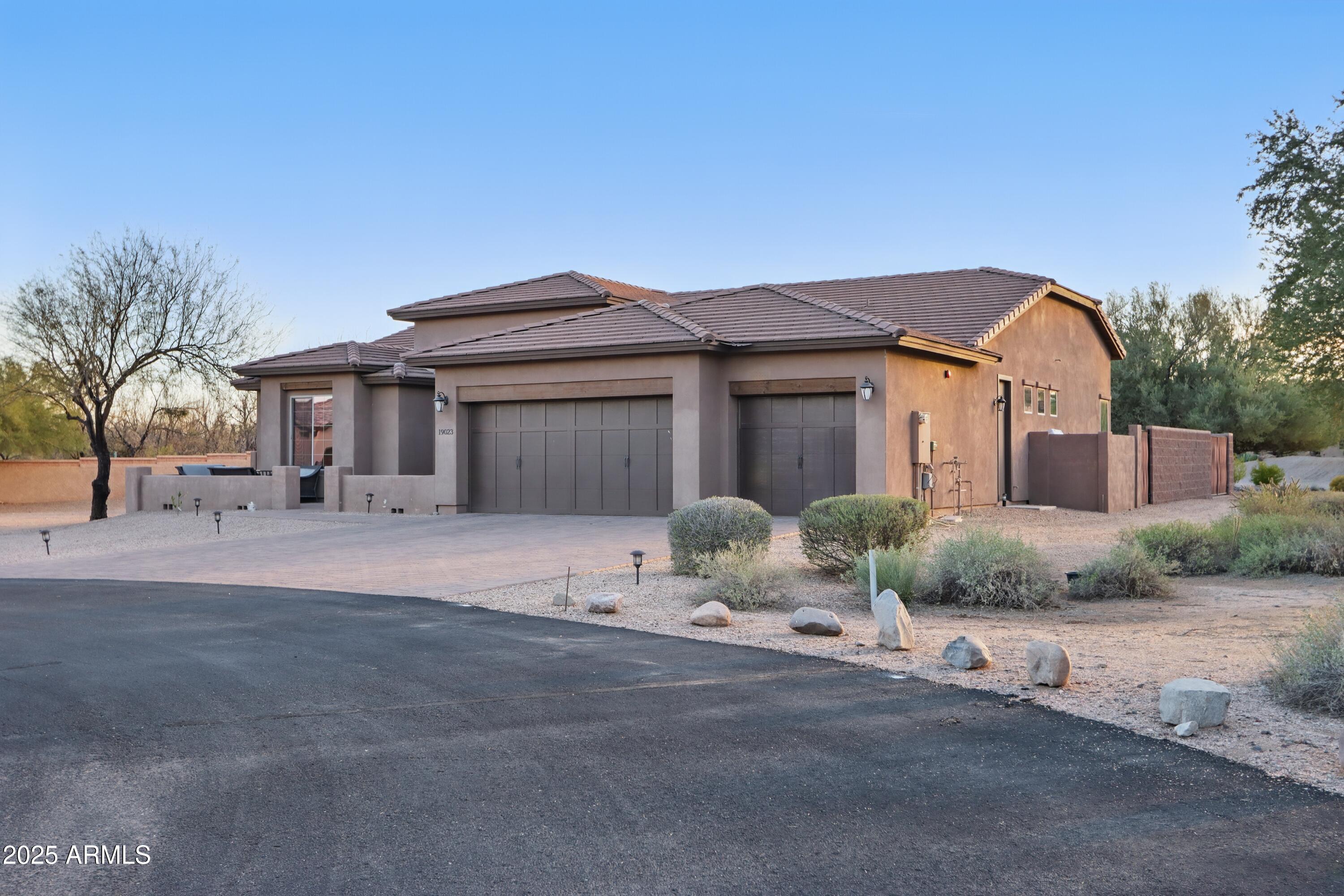 19023 East Buckskin Drive Rio Verde, AZ 85263 - Photo 5 of 58 a front view of a house with a yard and garage