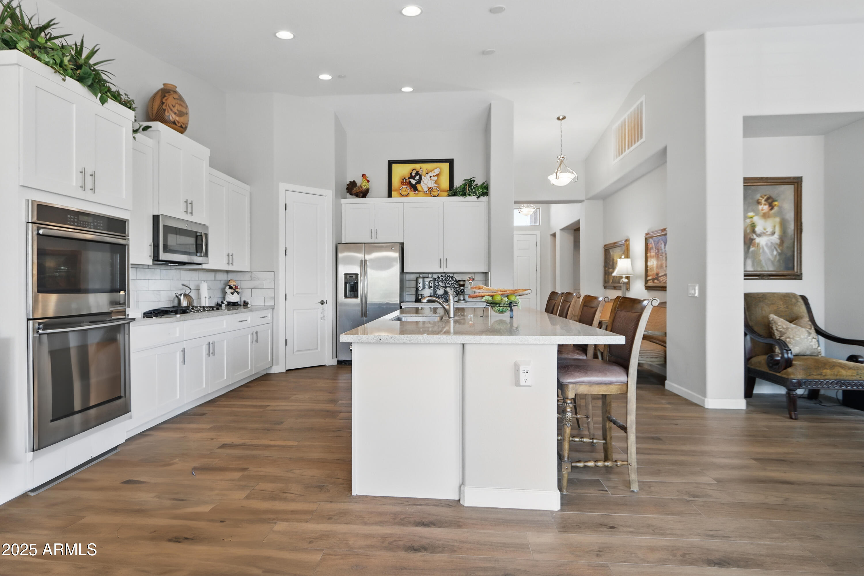 19023 East Buckskin Drive Rio Verde, AZ 85263 - Photo 9 of 58 a kitchen with stainless steel appliances kitchen island granite countertop a stove a sink a microwave a dining table and chairs
