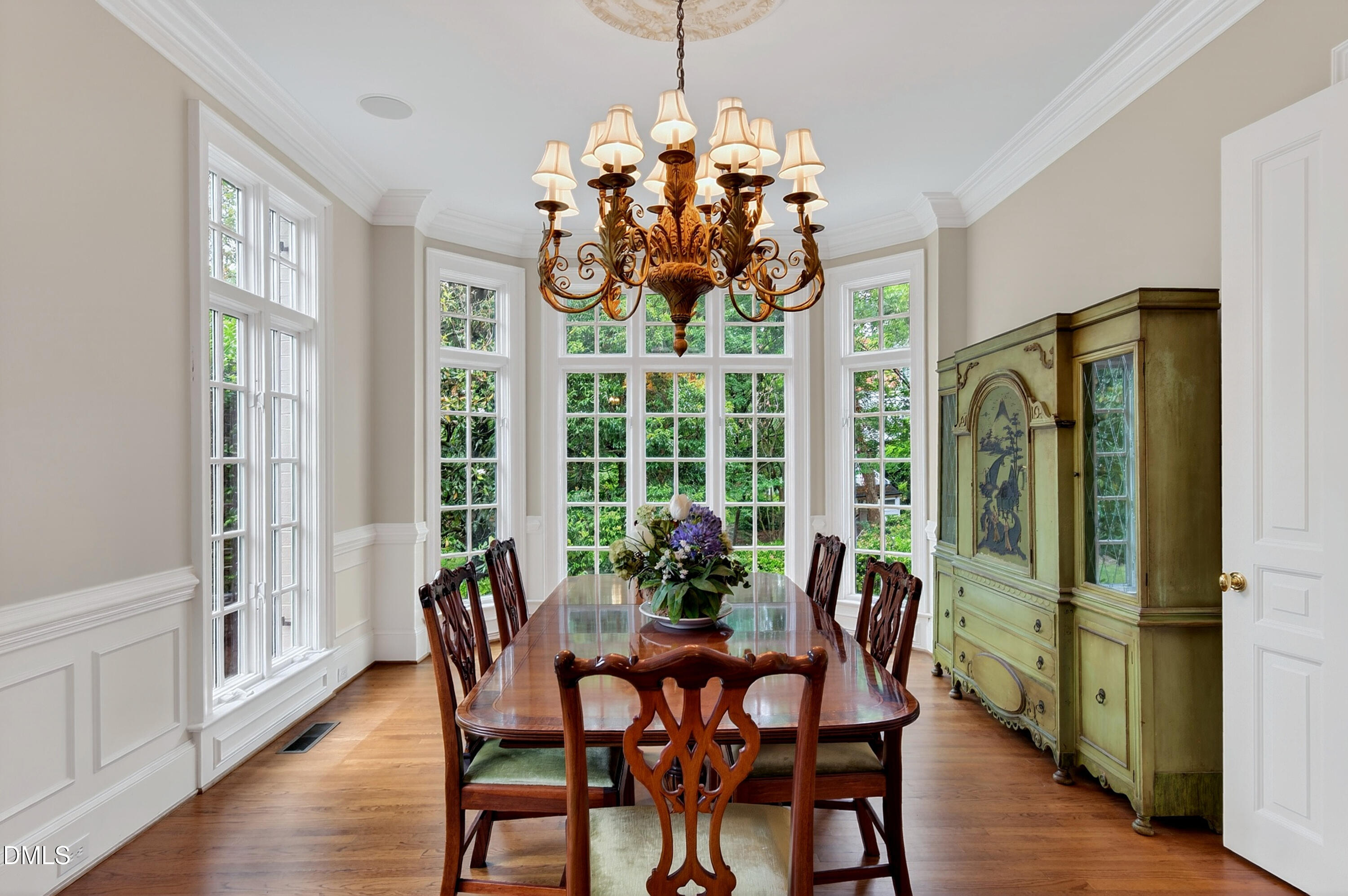 2536 Wake Drive Raleigh, NC 27608 - Photo 8 of 74 a dining room with furniture a chandelier and wooden floor