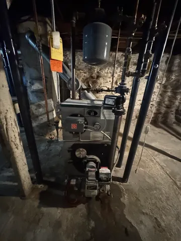a room with water heater and wooden racks