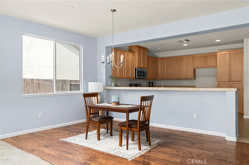 2135 Jacob Street Gridley, CA 95948 - Photo 18 of 50 a kitchen with a table chairs refrigerator and microwave