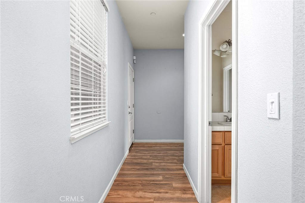2135 Jacob Street Gridley, CA 95948 - Photo 19 of 50 a view of a hallway with wooden floor and a bathroom
