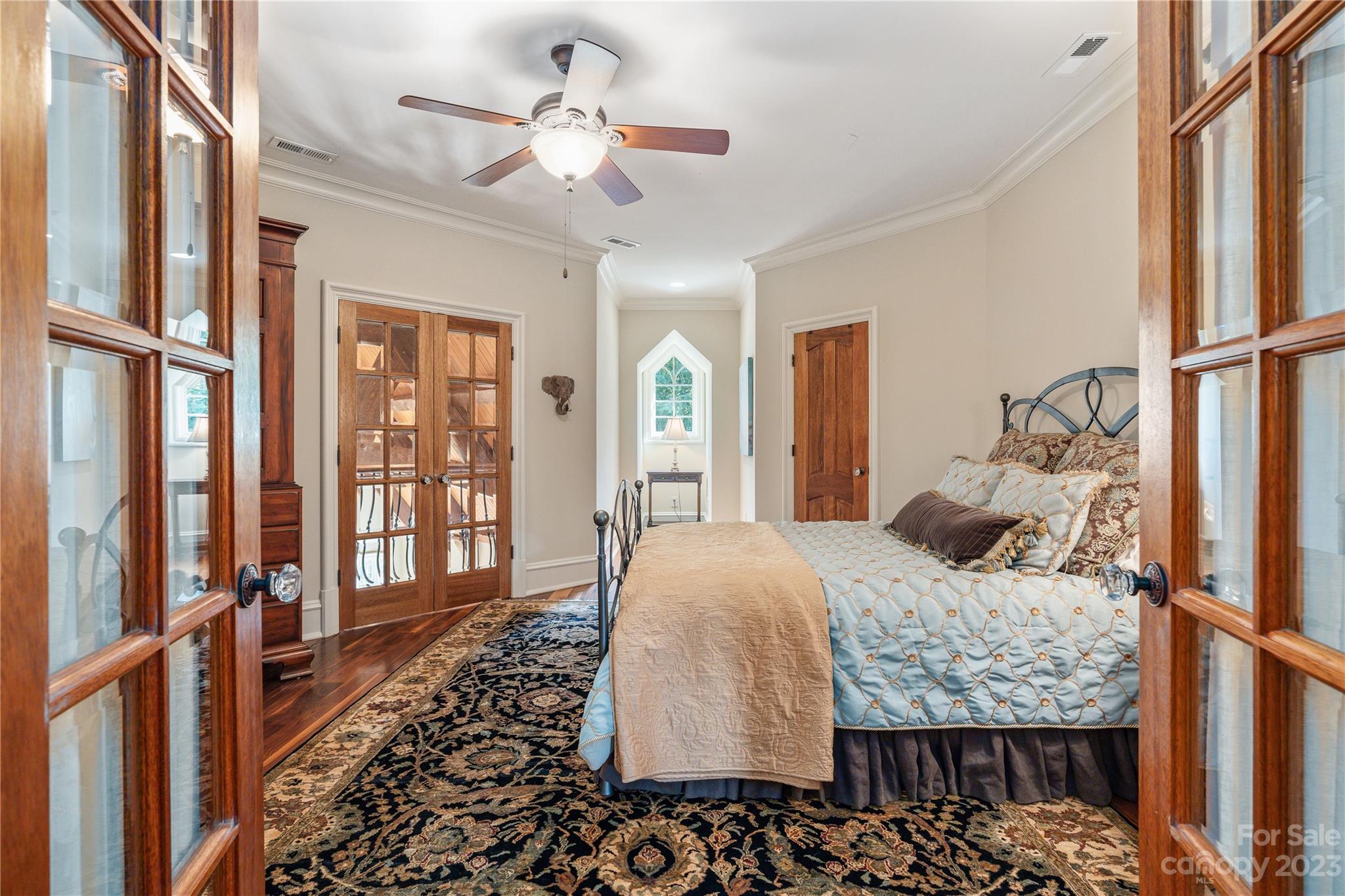1007 Eirlys Lane Matthews, NC 28104 - Photo 31 of 48 a bedroom with a large bed and a chandelier