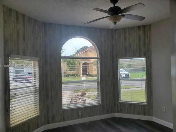 a view of room with window and ceiling fan