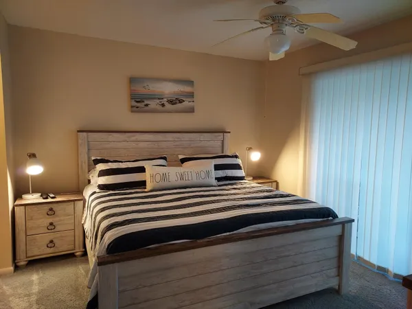 a bedroom with a bed and lamp