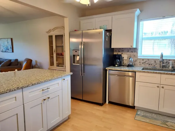 a kitchen with appliances a sink and cabinets