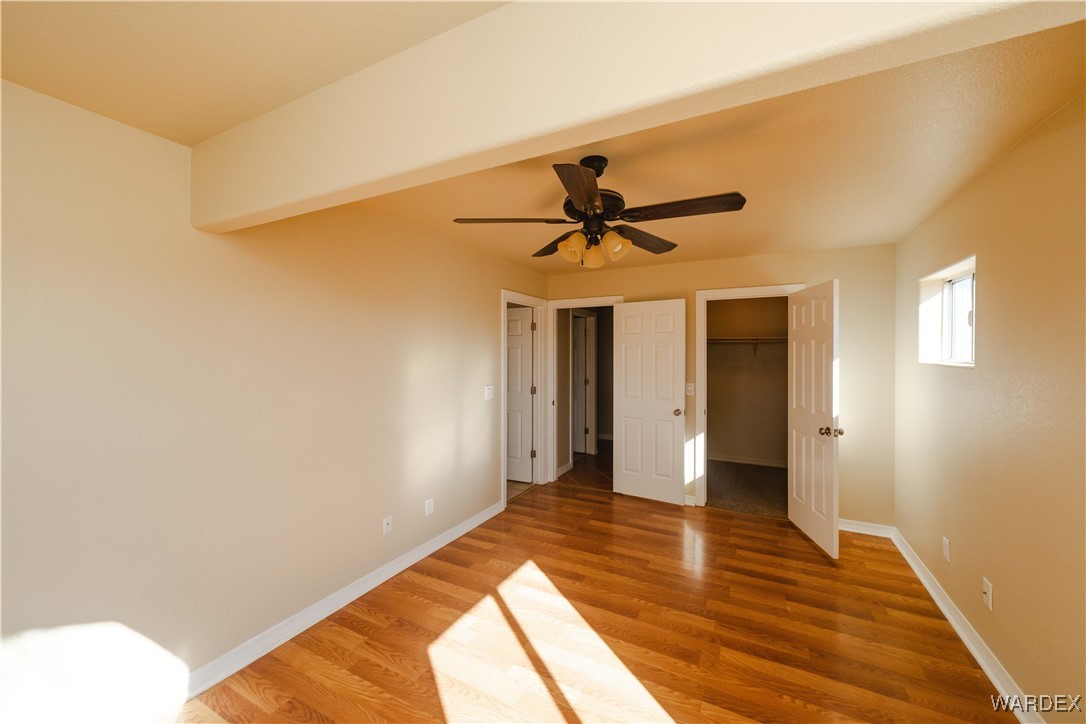 4246 Canelo Road Golden Valley, AZ 86413 - Photo 25 of 54 a view of empty room with wooden floor and fan