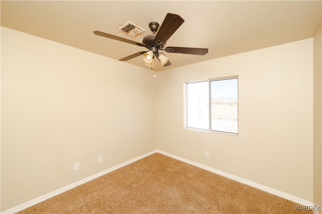 4246 Canelo Road Golden Valley, AZ 86413 - Photo 30 of 54 a view of a room with a ceiling fan and a window