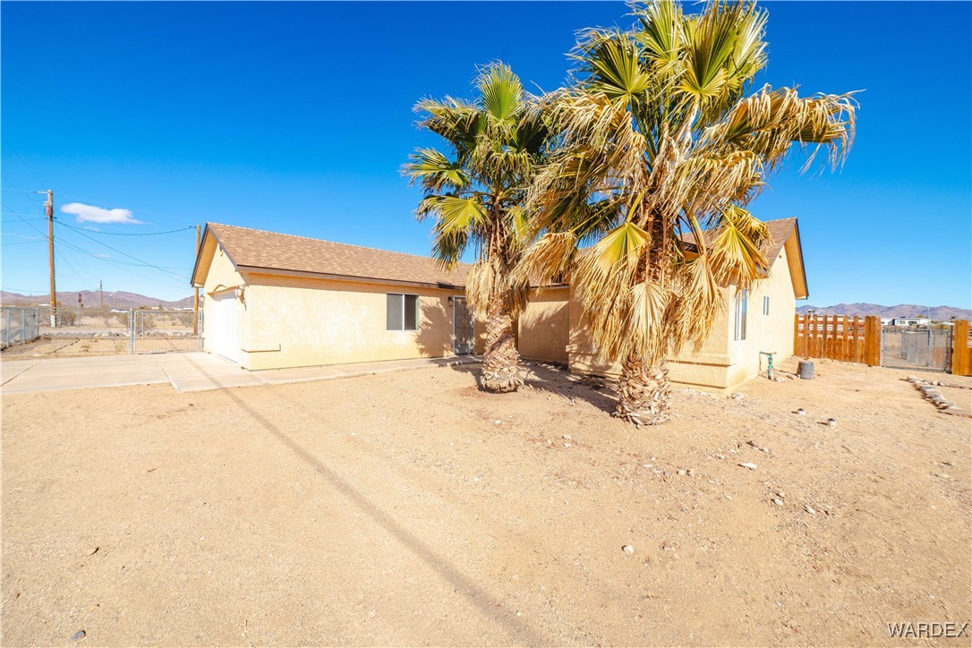 4246 Canelo Road Golden Valley, AZ 86413 - Photo 3 of 54 a house with a trees in the background