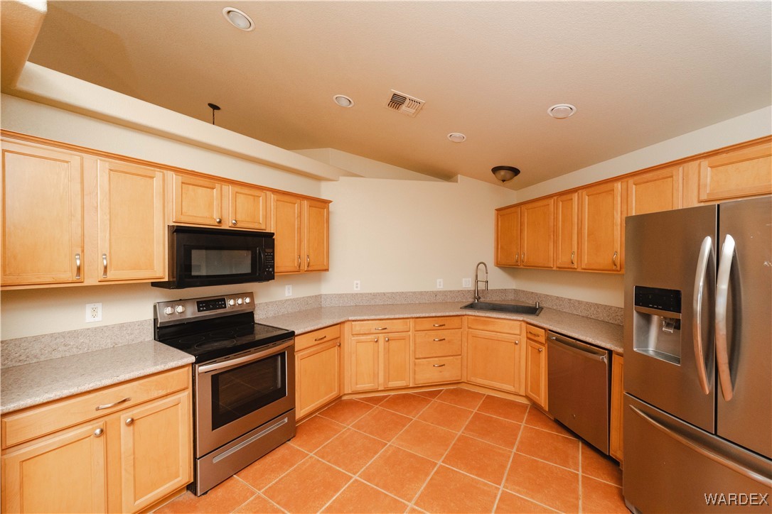 4246 Canelo Road Golden Valley, AZ 86413 - Photo 39 of 54 a kitchen with granite countertop a sink stainless steel appliances and cabinets