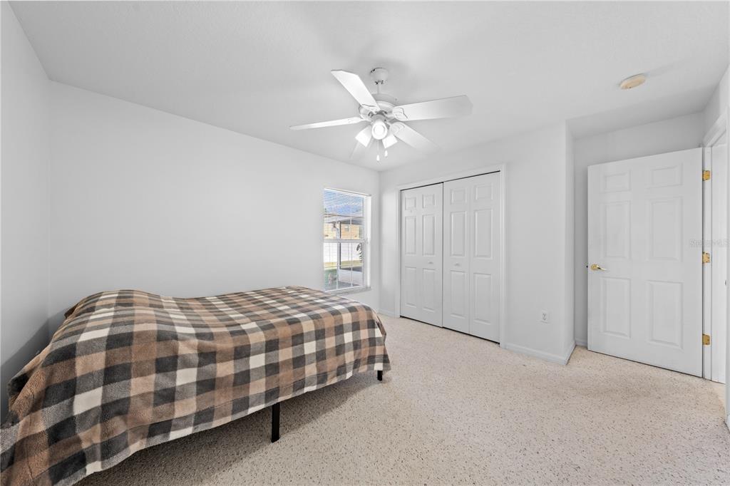 2708 Kayak Court St. Cloud, FL 34772 - Photo 24 of 56 a bedroom with a bed and a chandelier