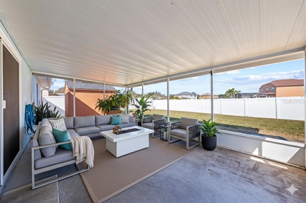 2708 Kayak Court St. Cloud, FL 34772 - Photo 6 of 56 a living room with furniture potted plant floor to ceiling window and potted plants