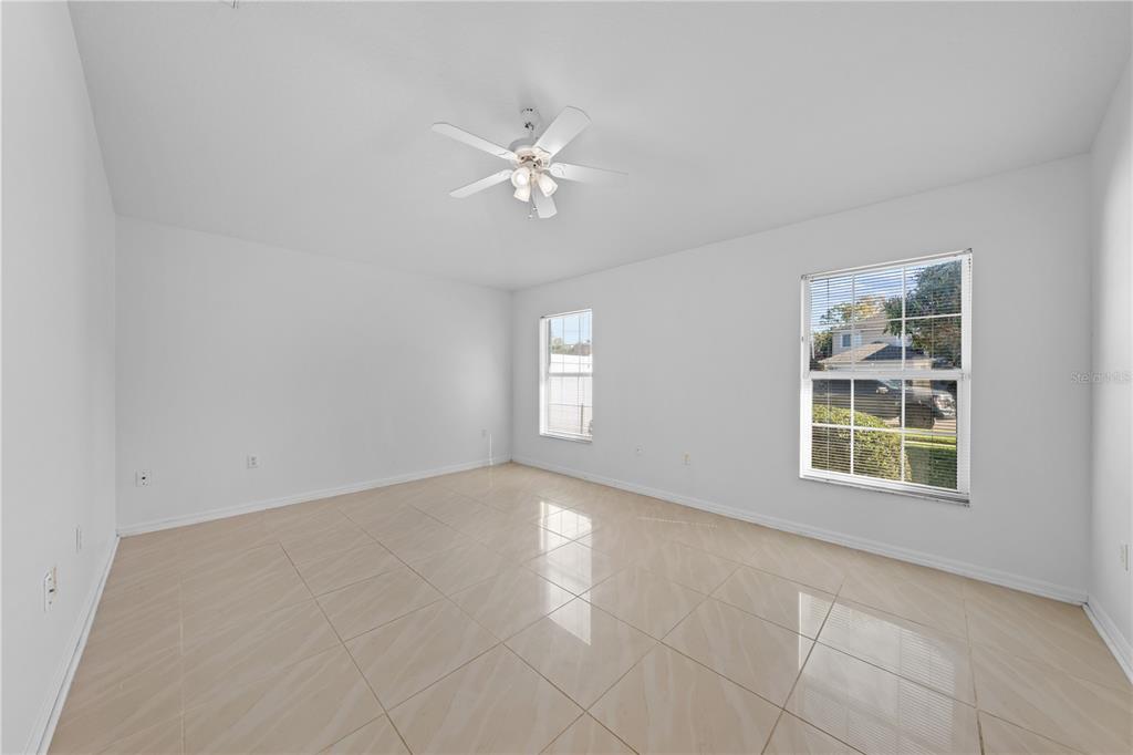 2708 Kayak Court St. Cloud, FL 34772 - Photo 10 of 56 an empty room with chandelier fan and windows