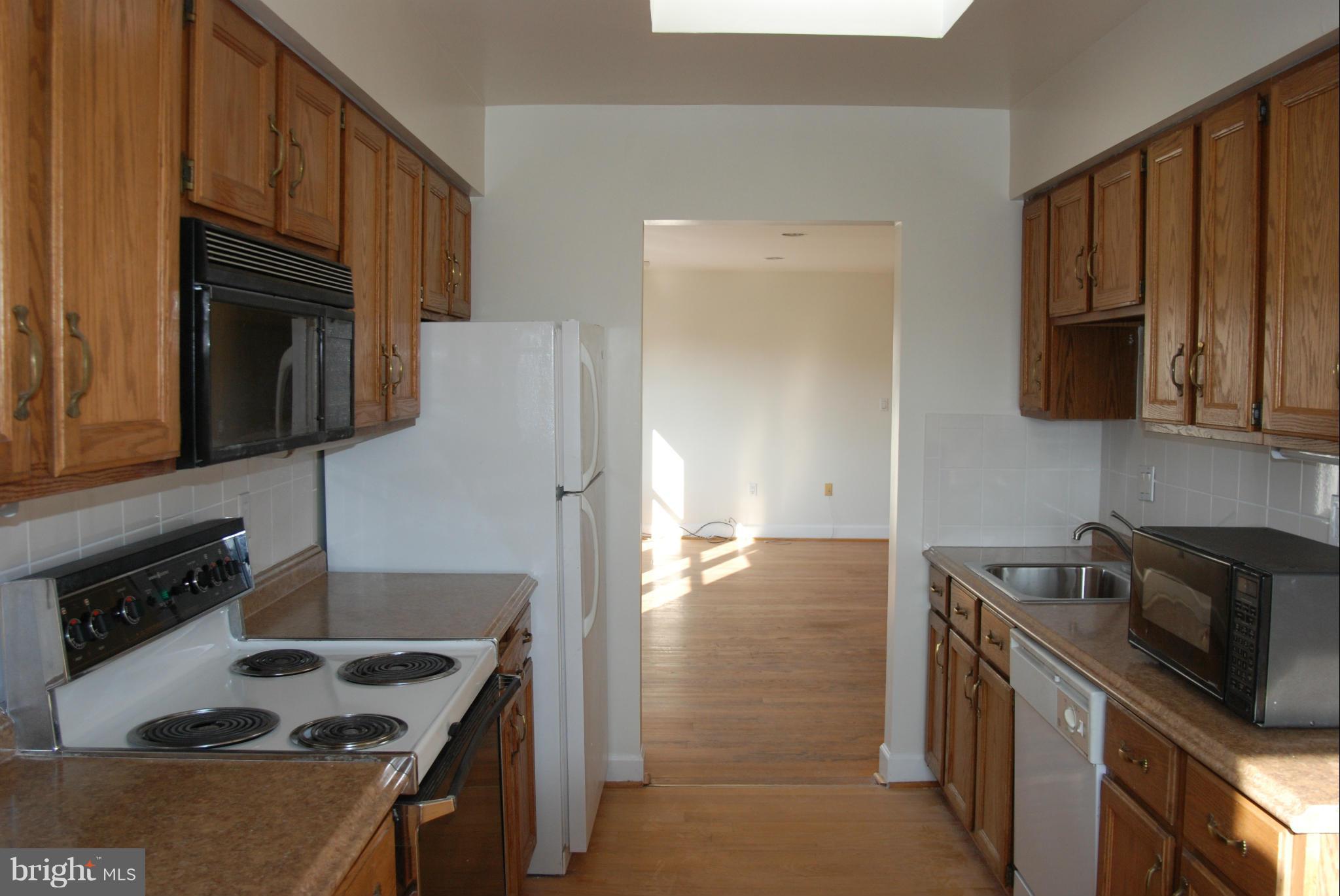 316 F Street Northeast, Unit 1 Washington, DC 20002 - Photo 3 of 18 a kitchen with granite countertop a sink stove and refrigerator