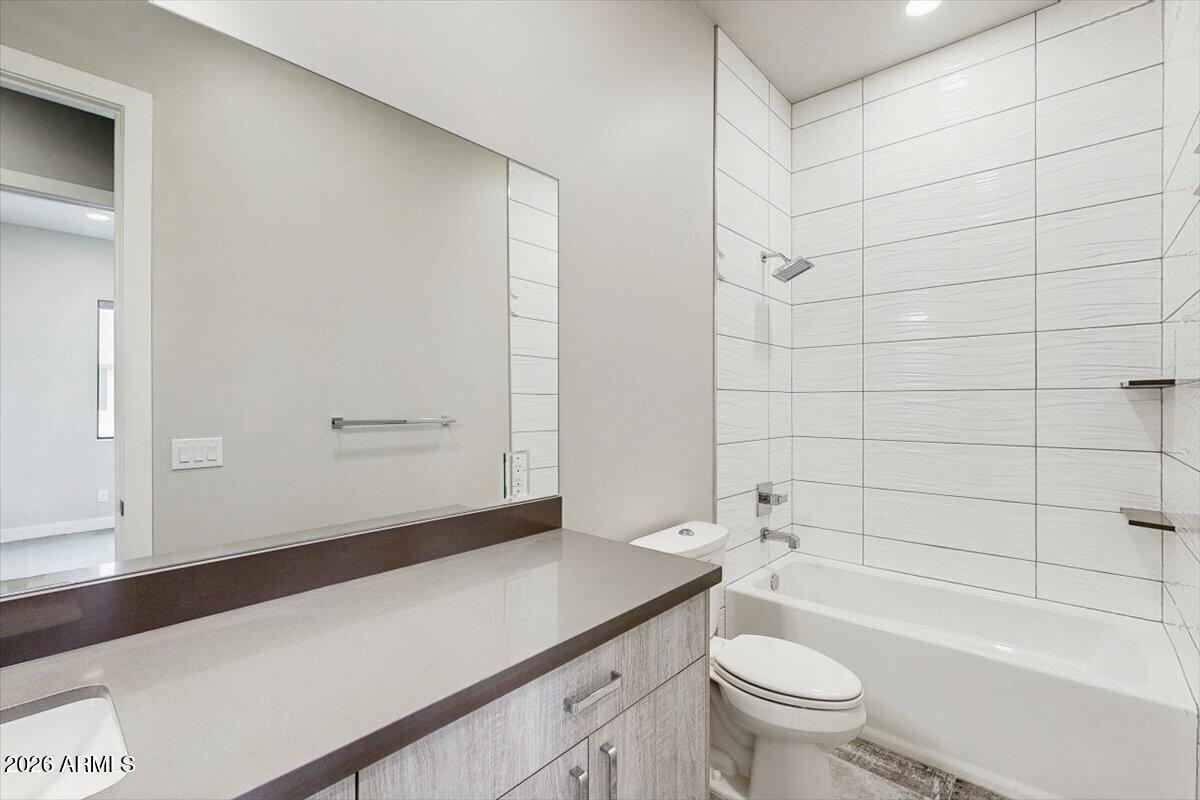 2645 East Osborn Road, Unit 3 Phoenix, AZ 85016 - Photo 13 of 14 a bathroom with a sink a toilet and shower