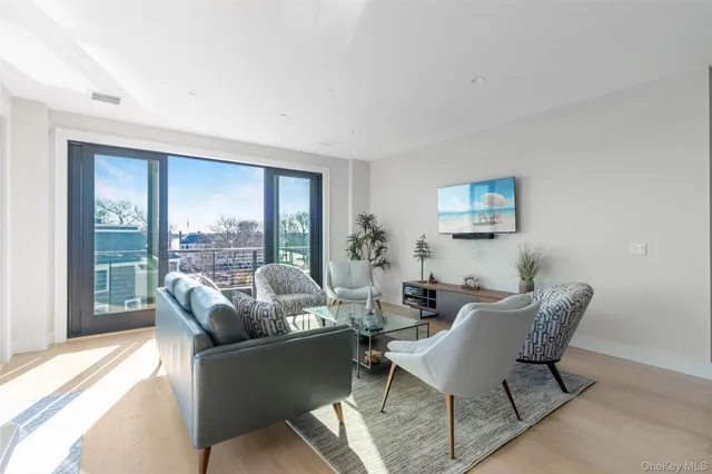 a living room with furniture and a floor to ceiling window