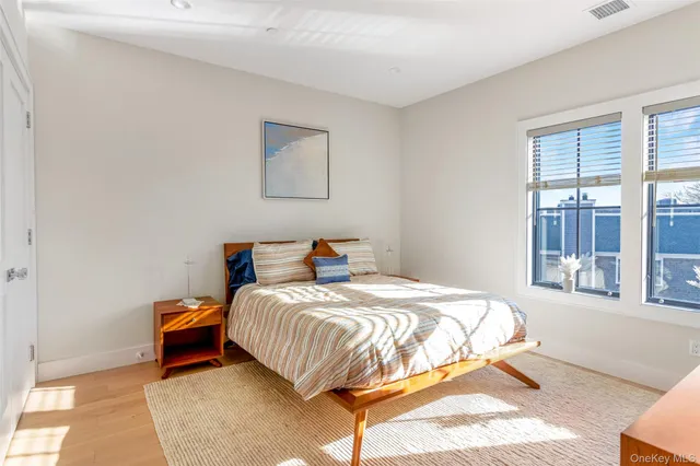 a bedroom with a large bed and a large window