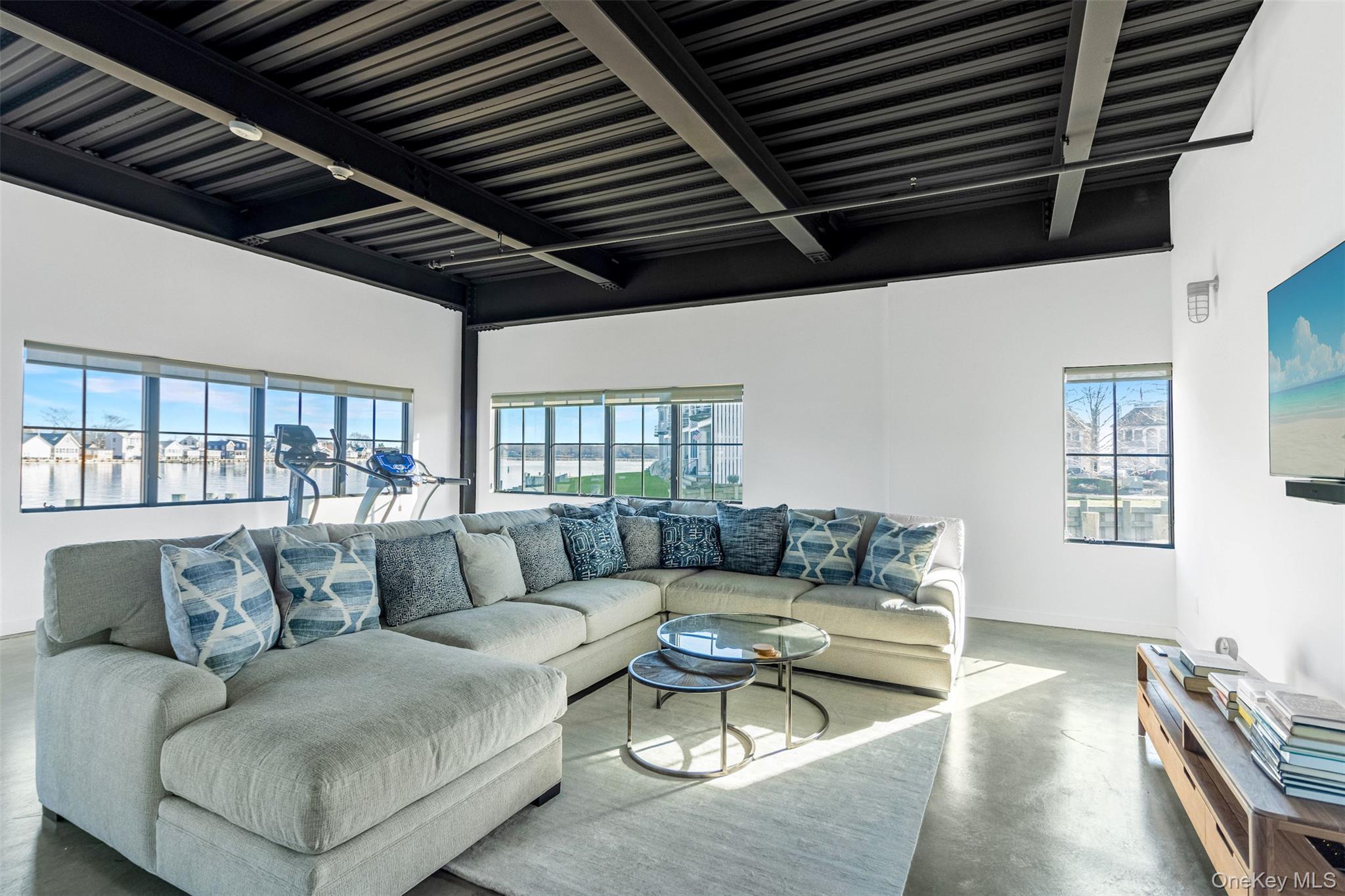 123 Sterling Avenue, Unit 12 Greenport, NY 11944 - Photo 22 of 29 a living room with furniture and a large window