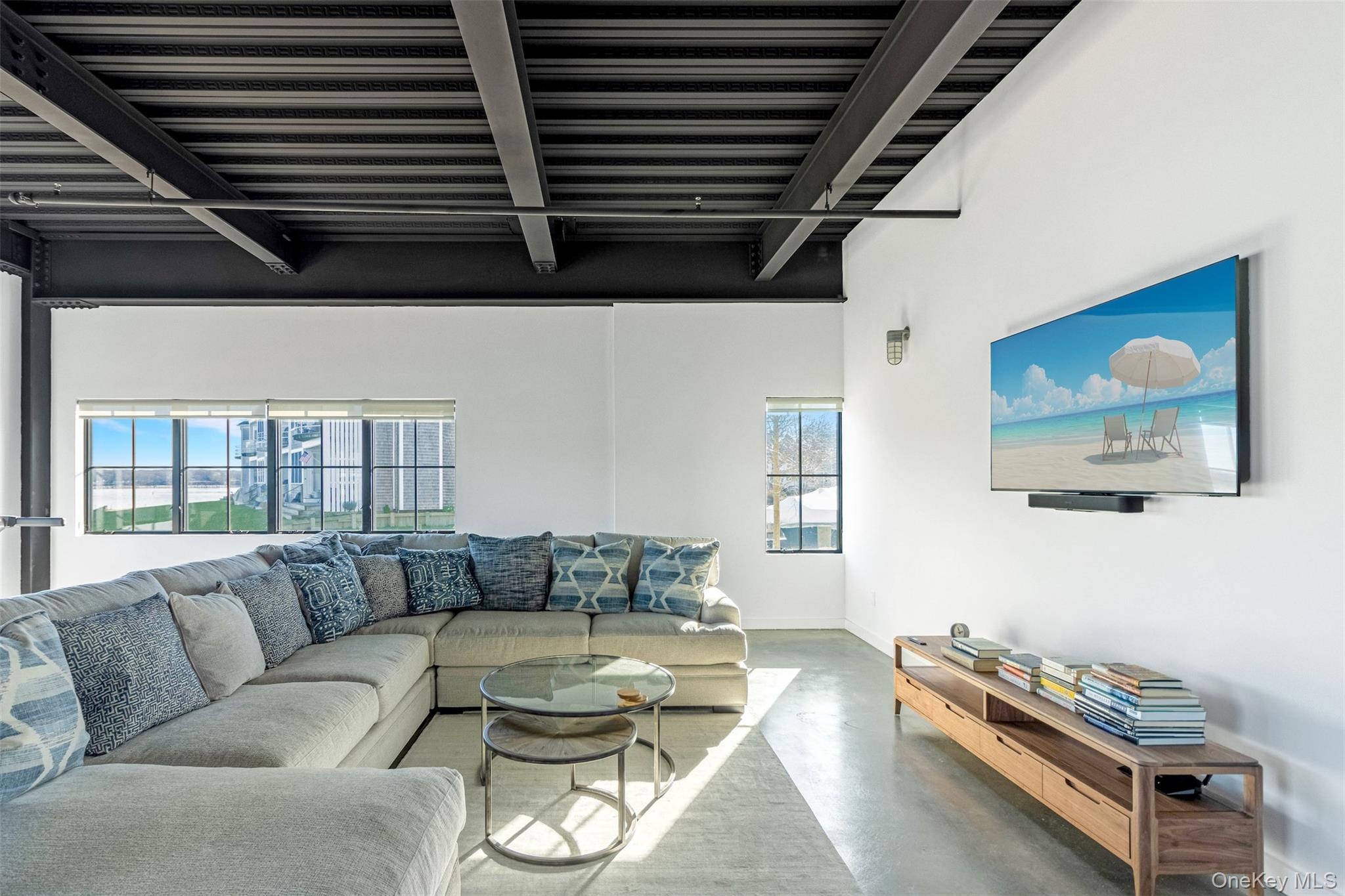 123 Sterling Avenue, Unit 12 Greenport, NY 11944 - Photo 24 of 29 a living room with furniture a rug and wall paintings