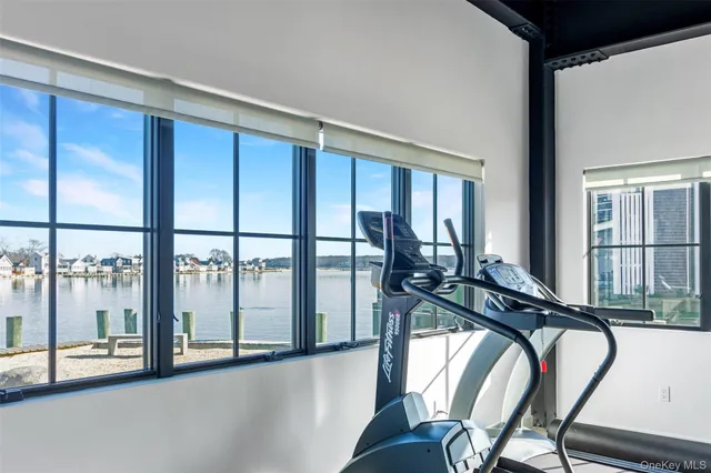 a living room with furniture a rug and wall paintings