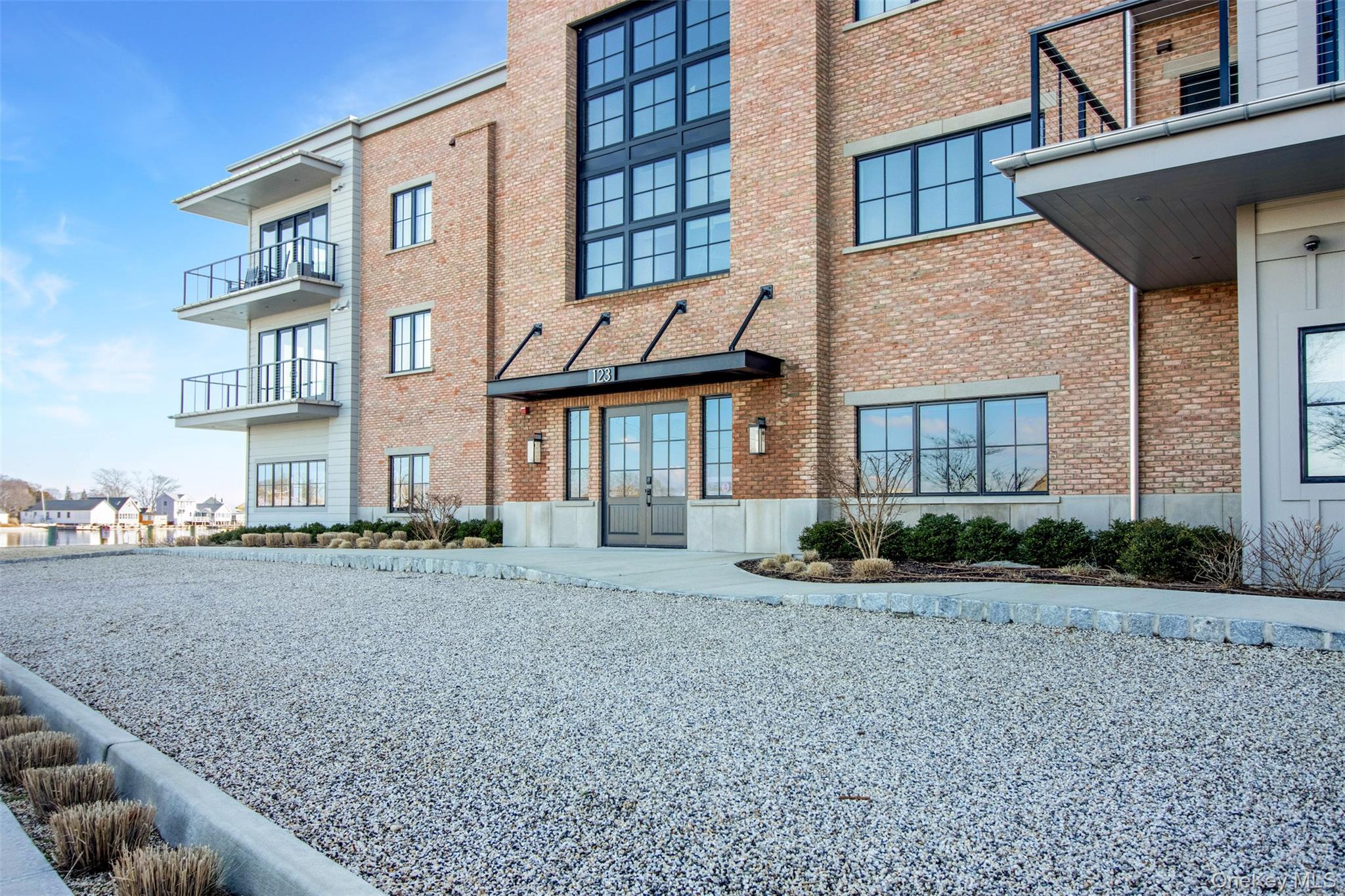 123 Sterling Avenue, Unit 12 Greenport, NY 11944 - Photo 28 of 29 a view of a brick house with many windows