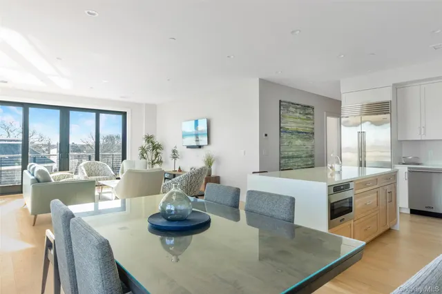 a living room with fireplace furniture and a large window