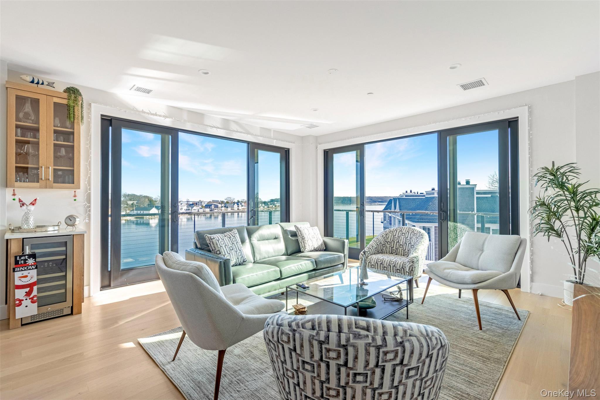 123 Sterling Avenue, Unit 12 Greenport, NY 11944 - Photo 9 of 29 a living room with furniture and a floor to ceiling window