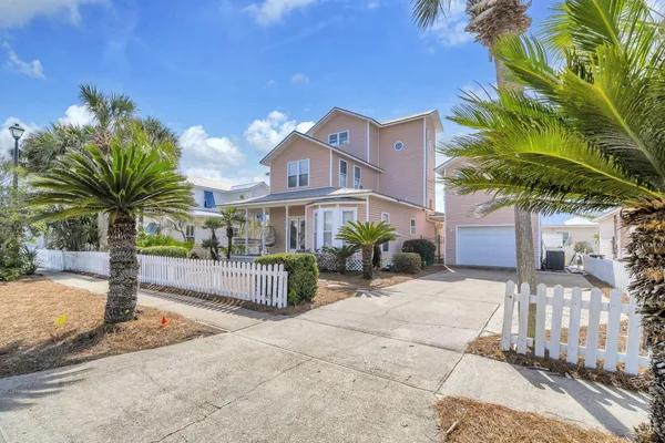 a view of a brick house in front of a yard