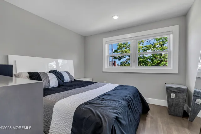 a bed sitting in a bedroom next to a window