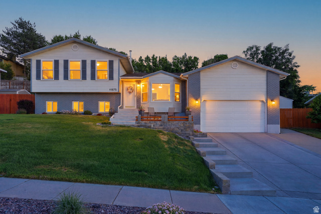 11875 South Elm Ridge Road Sandy, UT 84094 - Photo 1 of 53 Split-level residence featuring white siding, dark shutters, and a partial brick facade