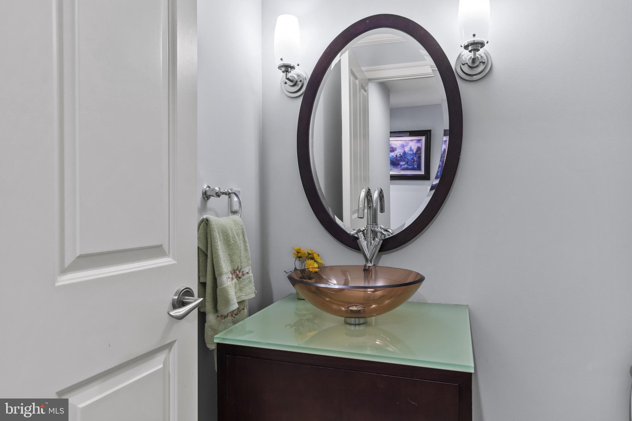 801 Key Highway, Unit 251 Baltimore, MD 21230 - Photo 27 of 57 a front view of a bathroom with sink and a mirror