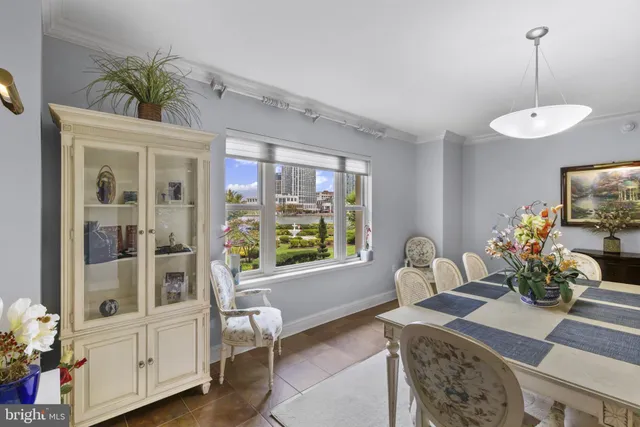 a dining room with furniture a chandelier and wooden floor