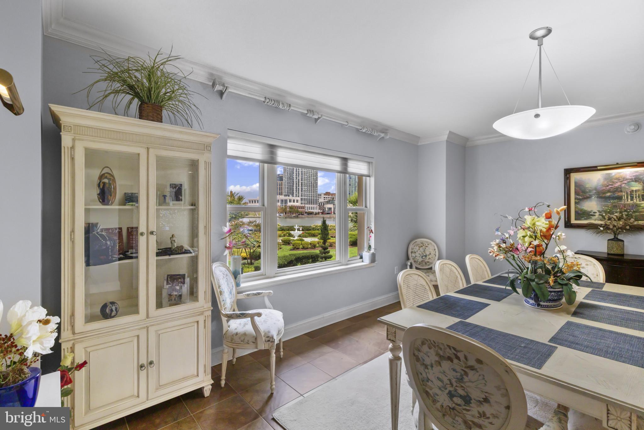 801 Key Highway, Unit 251 Baltimore, MD 21230 - Photo 3 of 57 a dining room with furniture a chandelier and wooden floor