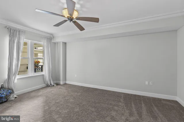 a view of a hallway and a livingroom with furniture