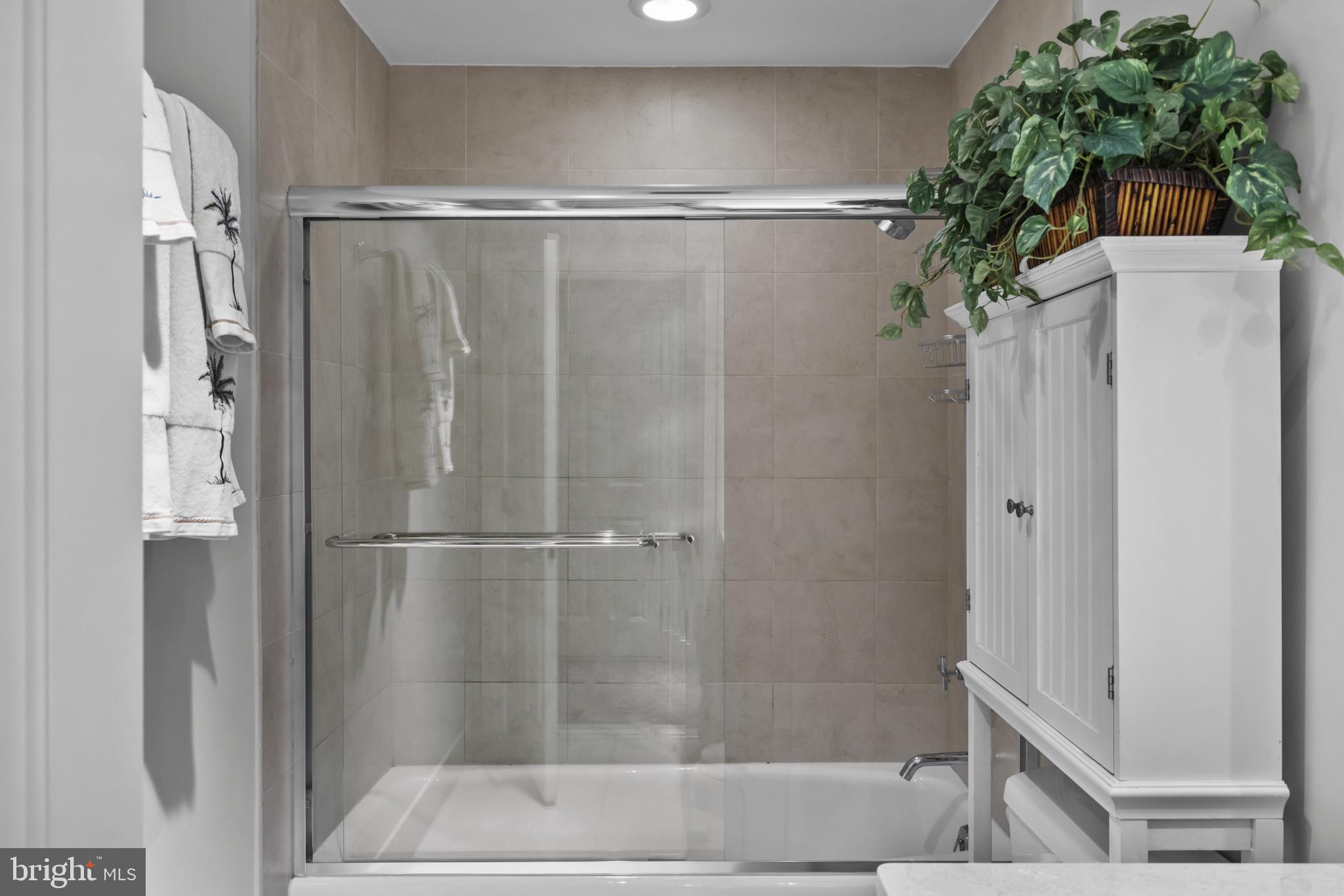 801 Key Highway, Unit 251 Baltimore, MD 21230 - Photo 40 of 57 a bathroom with a shower and a glass door