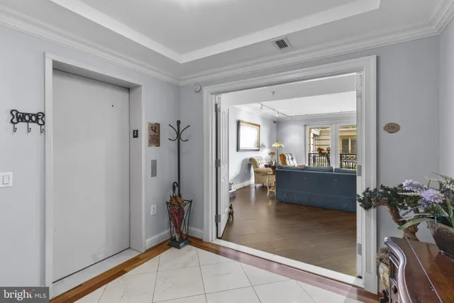 a dining room with furniture a chandelier and a rug