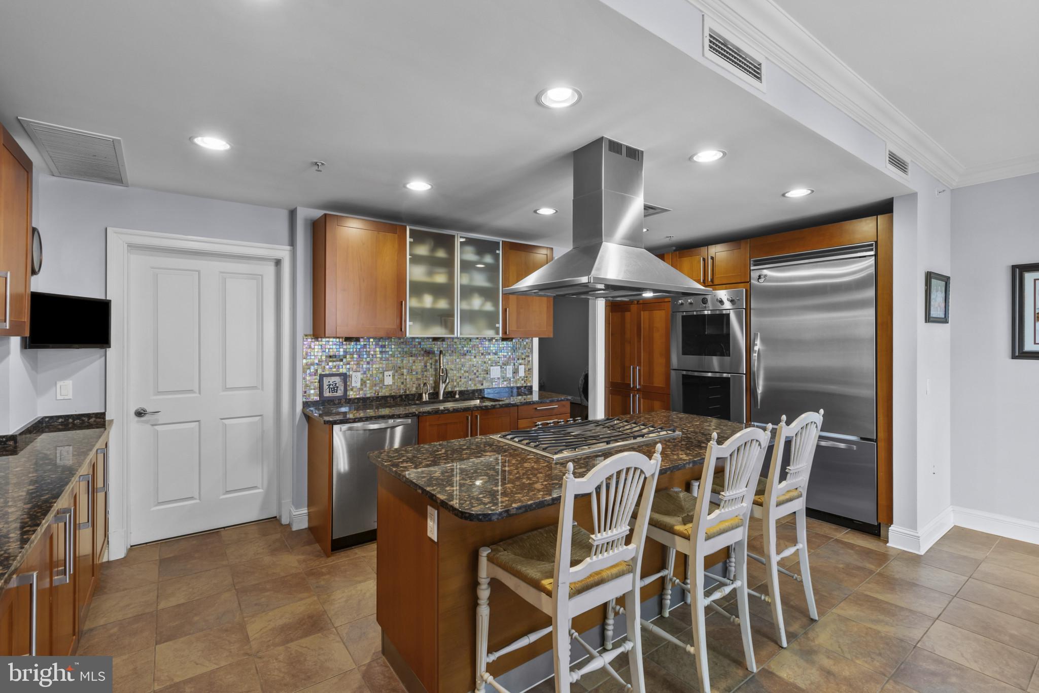 801 Key Highway, Unit 251 Baltimore, MD 21230 - Photo 8 of 57 a kitchen with granite countertop kitchen island stainless steel appliances a sink and a refrigerator