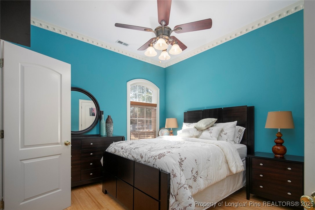 5304 Pineview Road Lumberton, NC 28360 - Photo 27 of 49 a bedroom with a bed and a chandelier