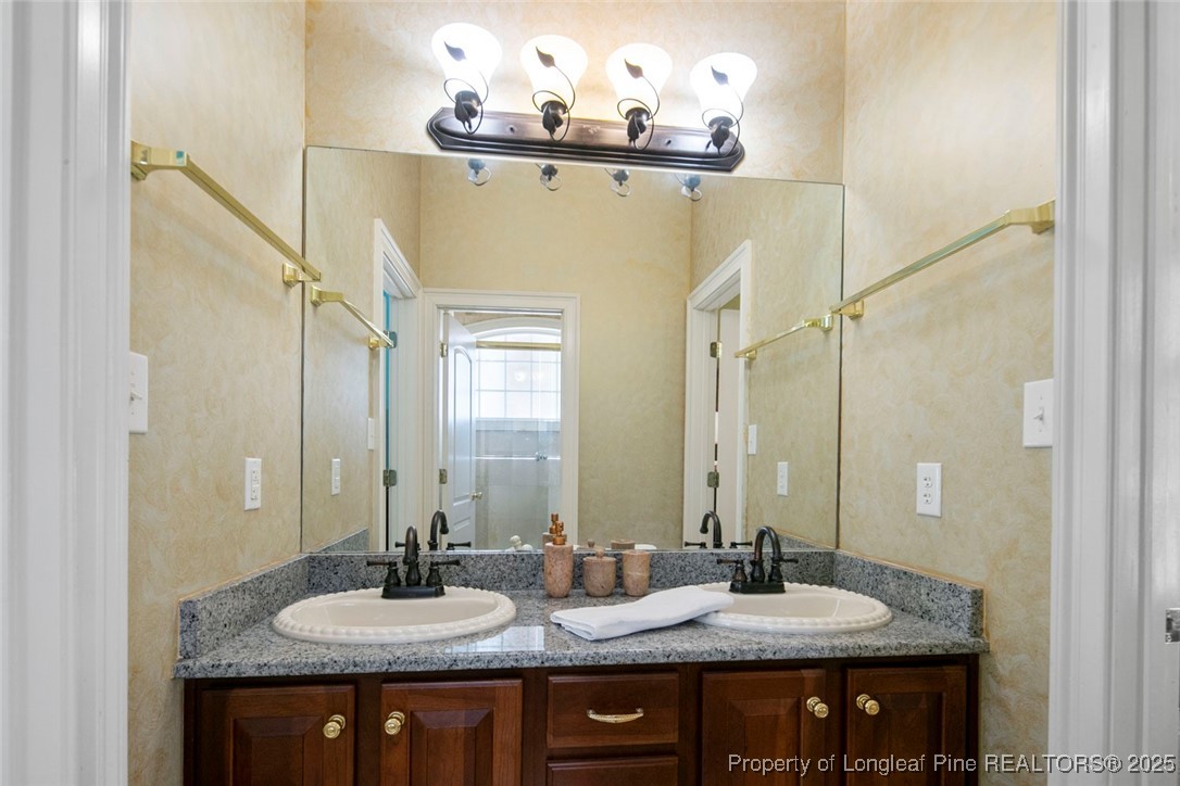 5304 Pineview Road Lumberton, NC 28360 - Photo 30 of 49 a bathroom with a granite countertop sink and a mirror