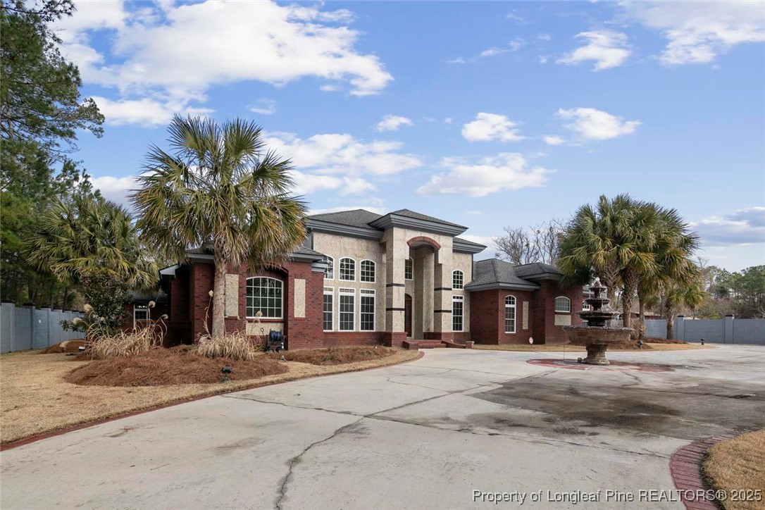5304 Pineview Road Lumberton, NC 28360 - Photo 3 of 49 a front view of a building with a garden and trees