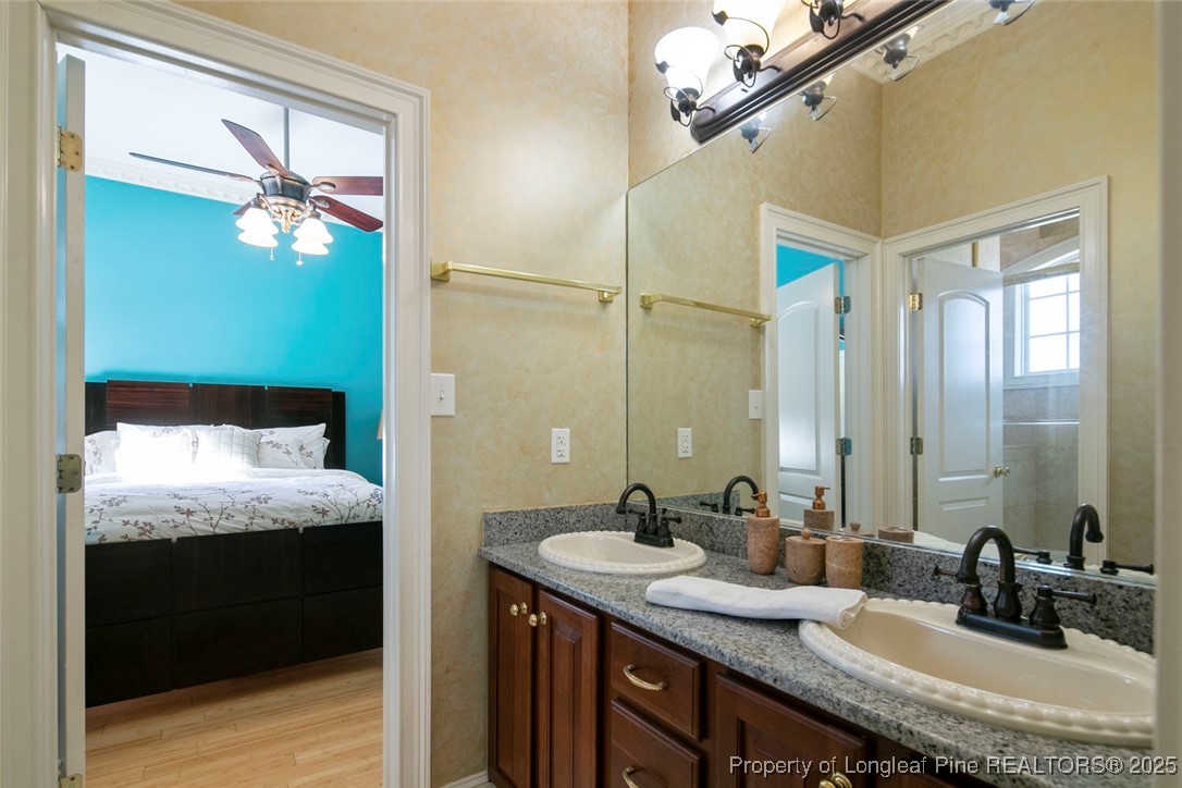 5304 Pineview Road Lumberton, NC 28360 - Photo 33 of 49 a bathroom with a granite countertop sink a large mirror and a shower