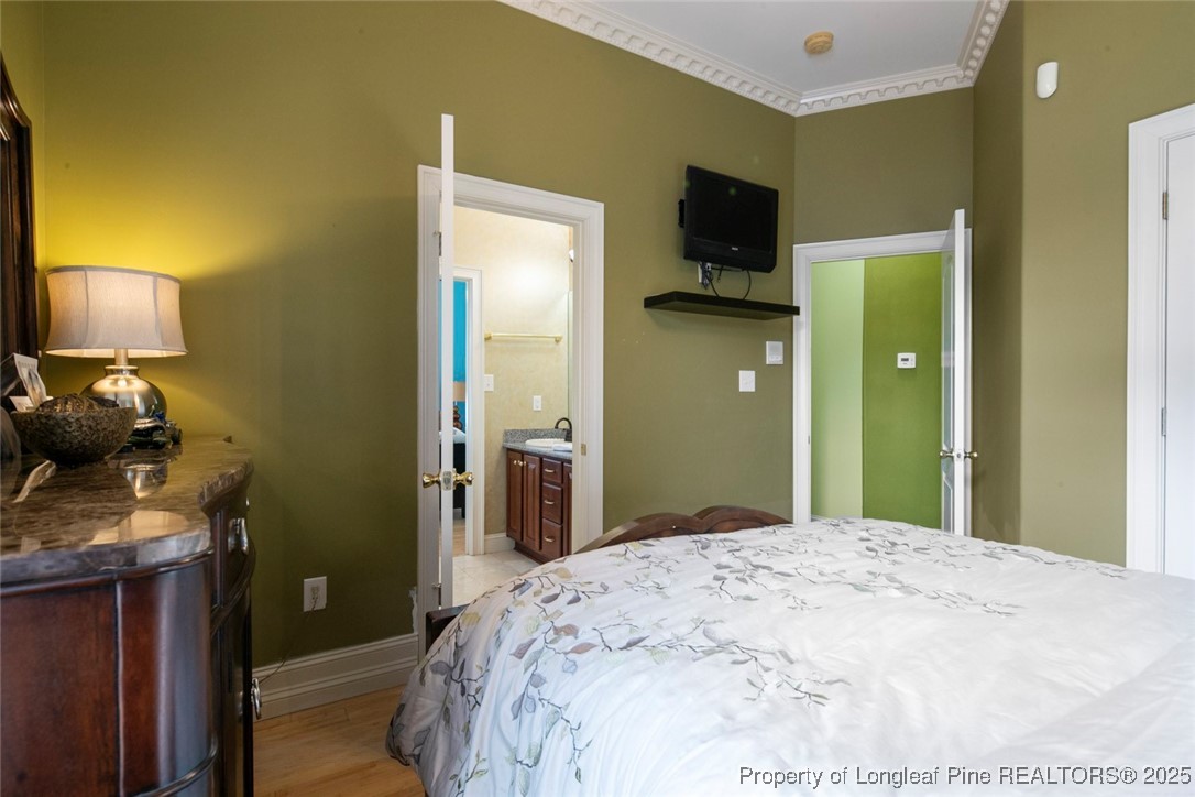 5304 Pineview Road Lumberton, NC 28360 - Photo 35 of 49 a bedroom with a bed and a flat tv screen on dresser