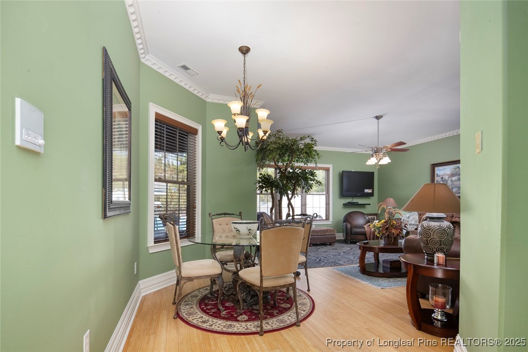 5304 Pineview Road Lumberton, NC 28360 - Photo 37 of 49 a living room with furniture a chandelier and a dining room
