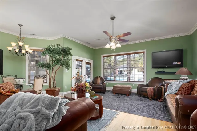 a bedroom with a bed a large window and glass door